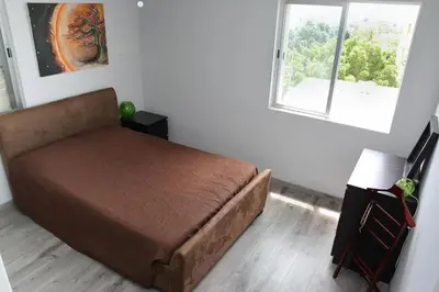 a bedroom with a bed and a window at Salt Lake view Apartment in Larnaka