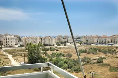 a view of a city from a balcony at Salt Lake view Apartment in Larnaka