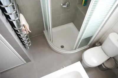 a bathroom with a shower with a toilet and a sink at Salt Lake view Apartment in Larnaka