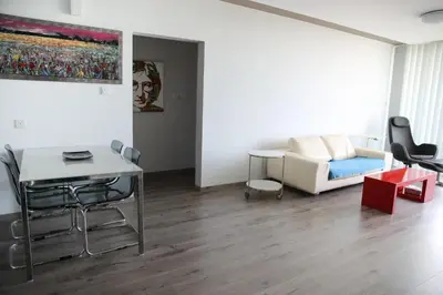 a living room with a couch and a table at Salt Lake view Apartment in Larnaka
