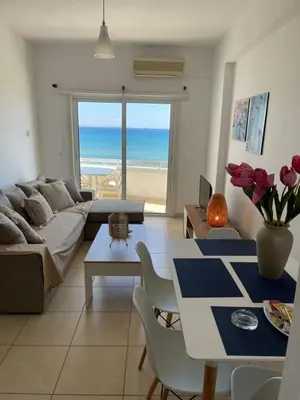 a living room with a couch and a table at Alex Beach Apartment 31 in Larnaka