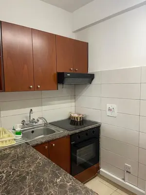a kitchen with a sink and a stove at Alex Beach Apartment 31 in Larnaka