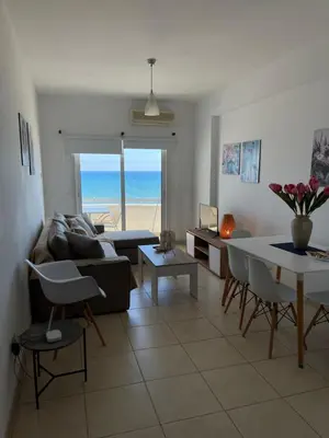 a living room with a couch and a table at Alex Beach Apartment 31 in Larnaka