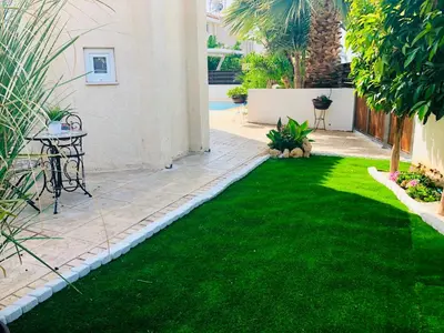 a small yard with green grass and a patio at Panorama Luxury Villa in Protaras