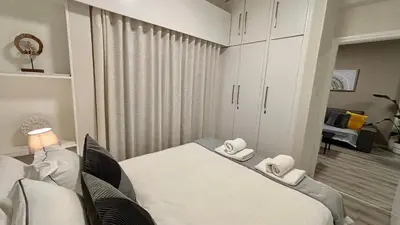 a bedroom with a bed with two towels on it at SeaBreeze City Center Flats by TrulyCyprus in Limassol