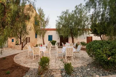 a group of tables and chairs in a courtyard at Meleni Cottage Houses in Parekklisha