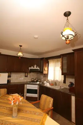 a kitchen with a wooden table and a dining room at Villa Vasa in Vasa Kilaniou