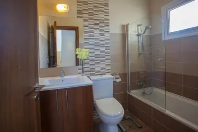 a bathroom with a toilet and a sink and a shower at Protaras Villa Anemoni 6 in Protaras