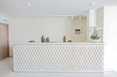 a white kitchen with a white counter top in a room at NissiLant hotel & suites in Ayia Napa