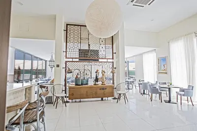 a kitchen and dining room with a table and chairs at NissiLant hotel & suites in Ayia Napa