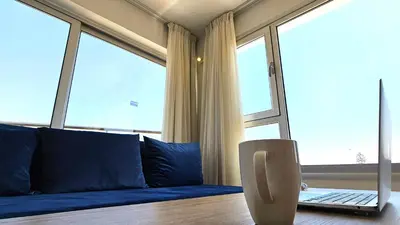 a living room with a couch and a laptop on a table at NissiLant hotel & suites in Ayia Napa