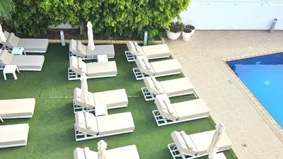 an overhead view of lounge chairs and a swimming pool at NissiLant hotel & suites in Ayia Napa