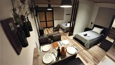 a room with a bed and a table with two sinks at Perneia Rooms in Askas