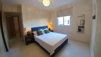 a bedroom with a bed and a window at Pyla Gardens D5 in Pyla