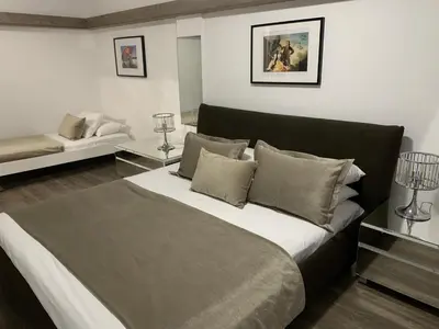 a bedroom with a large bed and a couch at Pasithea Holiday Apartments in Larnaka