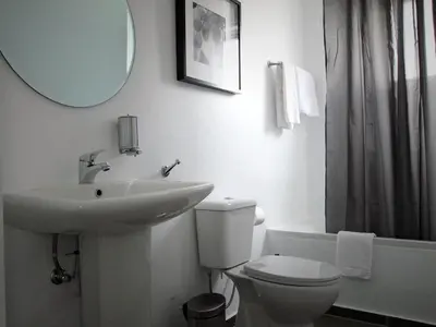 a bathroom with a sink and a toilet and a mirror at Pasithea Holiday Apartments in Larnaka