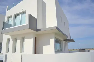 a white house with a balcony at T&E Villa in Larnaka