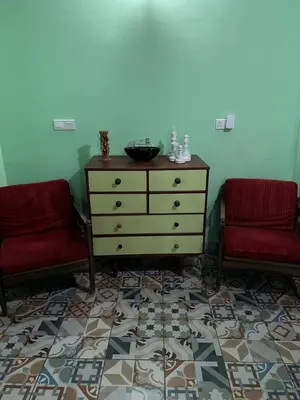a room with two chairs and a dresser in a room at Zouglas App Guesthouse in Limassol