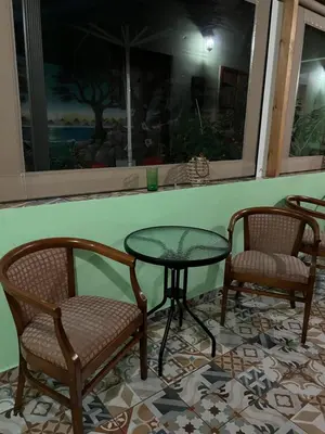 two chairs and a table and a table and chairs at Zouglas App Guesthouse in Limassol