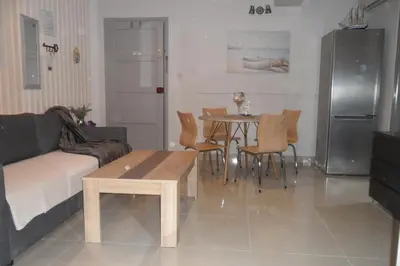 a living room with a couch and a table and chairs at Apartment Ground Floor, FREE INTERNET in Ayia Napa