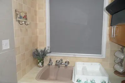a bathroom sink with a large window above it at Apartment Ground Floor, FREE INTERNET in Ayia Napa