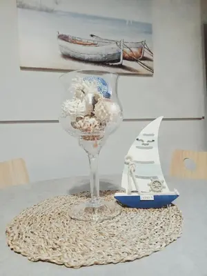 a wine glass on a table with a boat on it at Apartment Ground Floor, FREE INTERNET in Ayia Napa