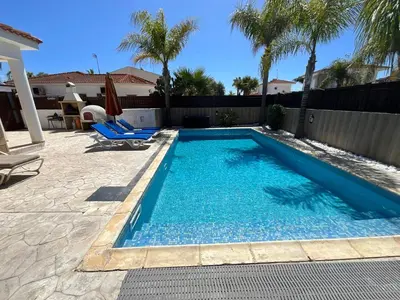 a swimming pool in the backyard of a house at Villa Gracia in Ayia Napa