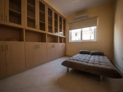 a bedroom with a bed and cabinets and a window at Panais Villa in Kiti