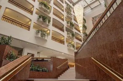 a staircase in a building with potted plants at St Raphael Resort in Limassol