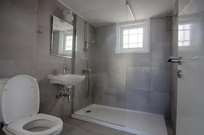 a bathroom with a toilet and a sink and a shower at Fig Tree Bay Villa 2 in Protaras