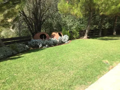 a woman laying on the grass in a garden at Agia Mavri House in Koilani
