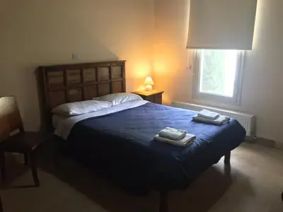 a bedroom with a bed with two towels on it at Agia Mavri House in Koilani