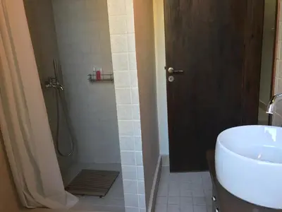 a bathroom with a shower and a sink and a toilet at Agia Mavri House in Koilani