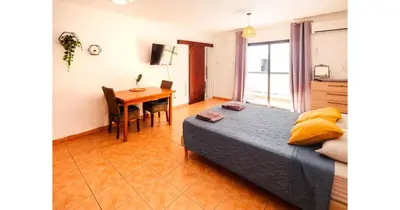a bedroom with a bed and a table and a dining room at Urban Stays in Ayia Napa