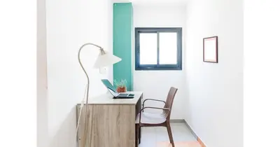 a room with a desk with a laptop and a chair at Urban Stays in Ayia Napa