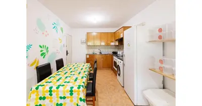 a kitchen with a dining room table and a refrigerator at Urban Stays in Ayia Napa
