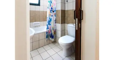 a bathroom with a toilet and a shower curtain at Urban Stays in Ayia Napa