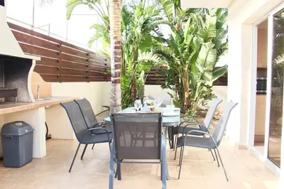 a dining table and chairs on a patio at Villa Agnes in Ayia Napa
