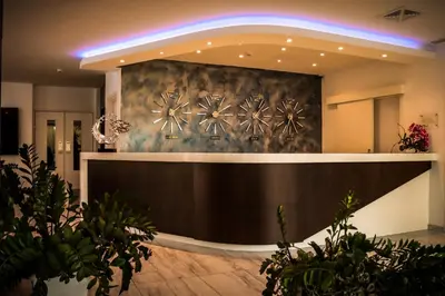 a lobby with a reception desk with plants at Gaia Sun N Blue Hotel in Ayia Napa