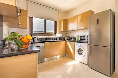 a kitchen with a stainless steel refrigerator and a dishwasher at Greko Mare Front Line in Protaras