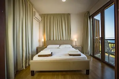 a bedroom with a bed and a large window at Greko Mare Front Line in Protaras