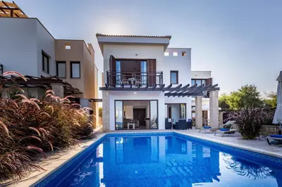 a villa with a swimming pool in front of a house at Greko Mare Front Line in Protaras