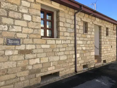 a brick building with a window and a sign on it at Arsos Village Apartment in Arsos