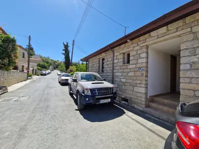a car parked next to a building on a street at Arsos Village Apartment in Arsos