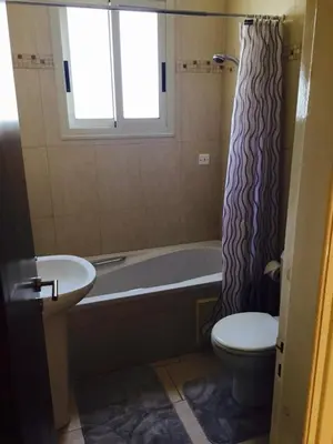 a bathroom with a tub and a toilet and a sink at Sunset Garden Villa in Pervolia