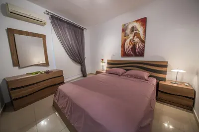 a bedroom with a large bed and a mirror at Skylight Megaron in Larnaka