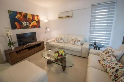 a living room with a couch and a table at Skylight Megaron in Larnaka