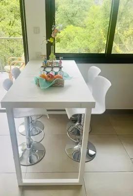 a white table in a room with a window at Riverside Suite in Kalopanayiotis