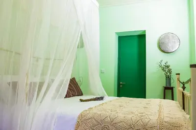 a bedroom with a bed with a white canopy at To Konatzi tis Marikas tzai tou Yianni in Kato Drys