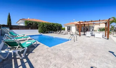 a patio with chairs and a swimming pool at Villa Marizan in Protaras